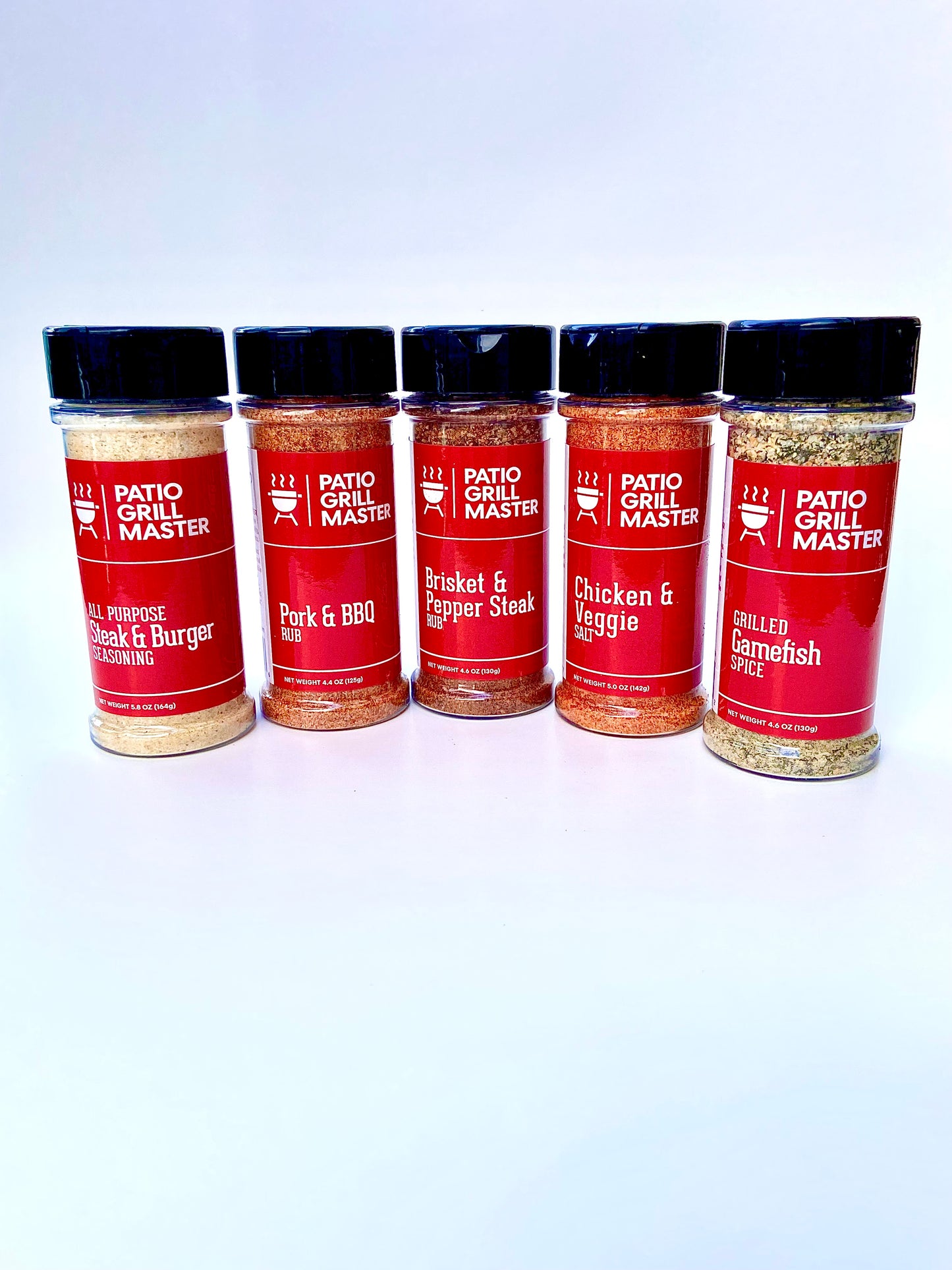 Five bottles of Patio Grill Master seasoning on a white background