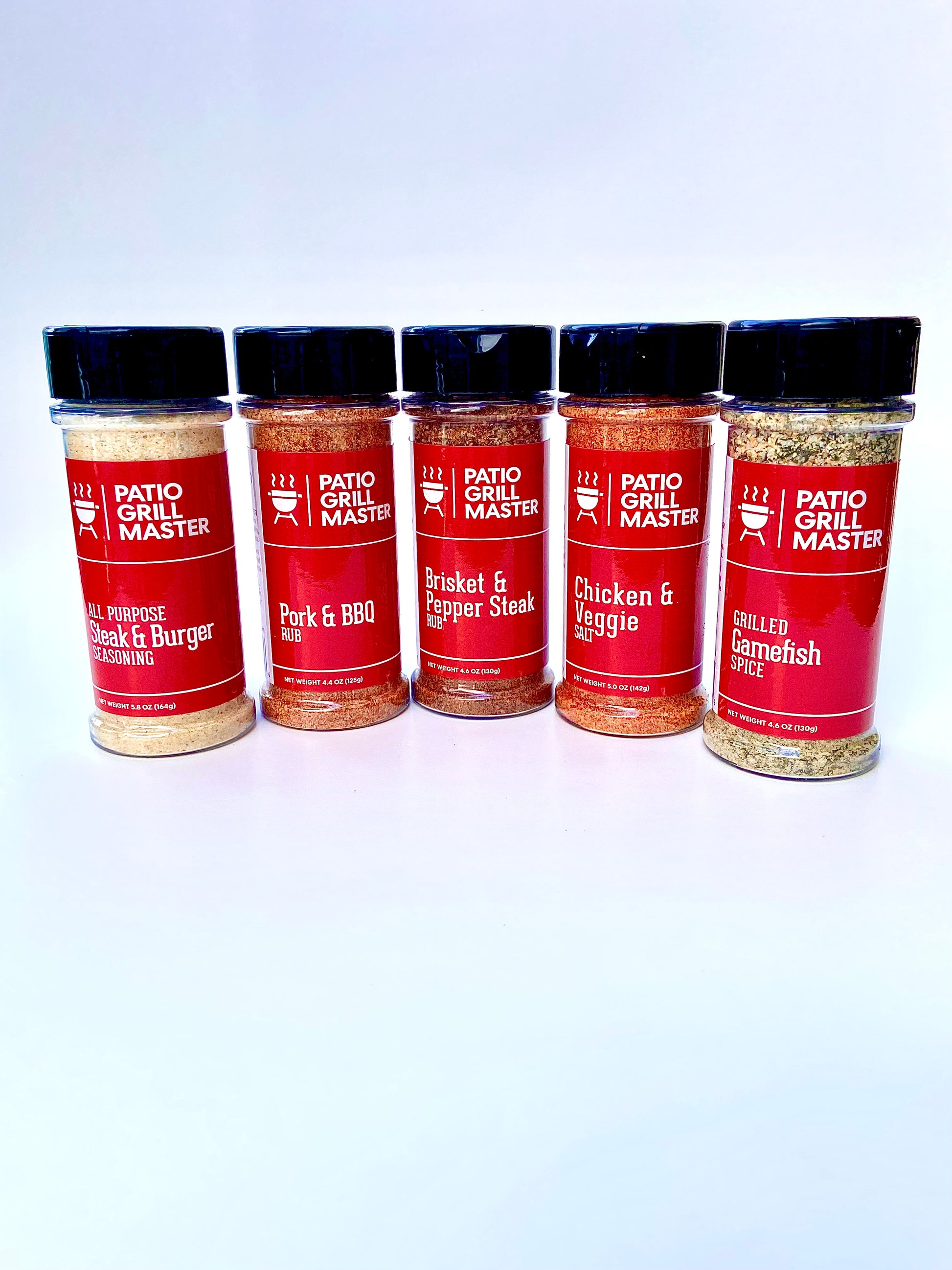 Five bottles of Patio Grill Master seasoning on a white background